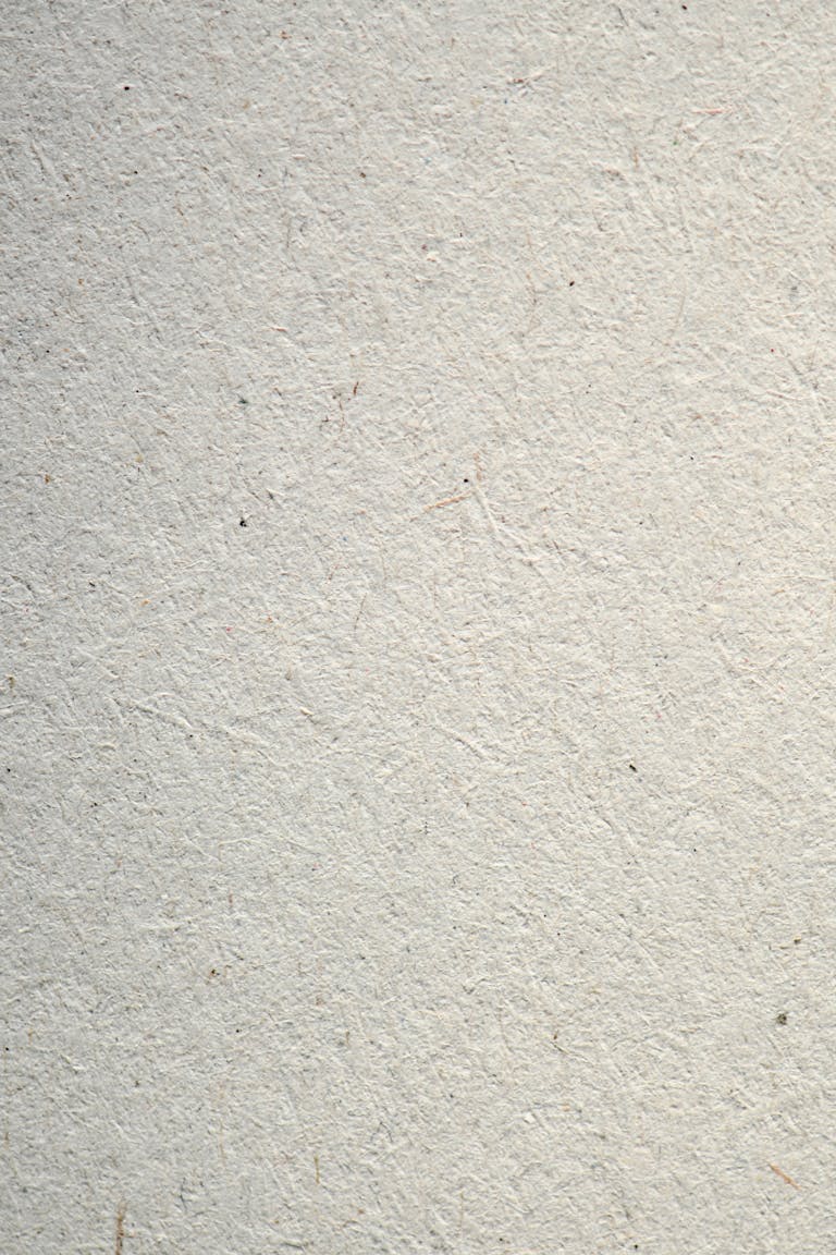 Closeup of a minimalist white textured paper background, ideal for design projects.