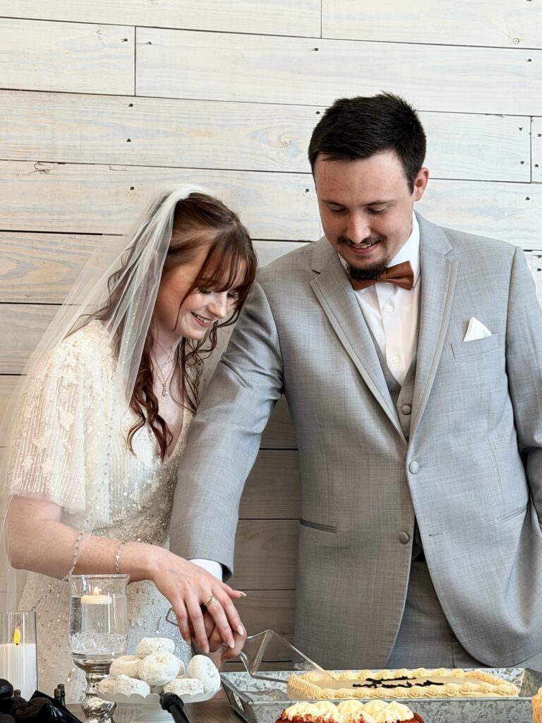 Within the Temple writer, Carly and her husband cutting their cake