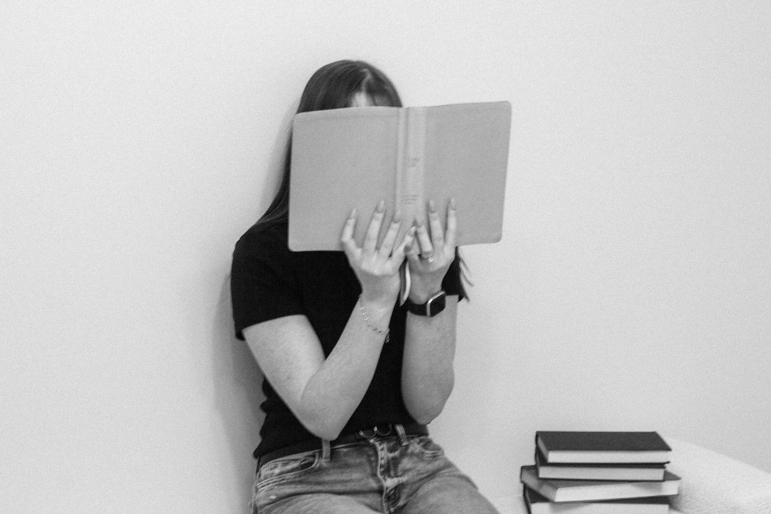 Carly beside a stack of Christian Books for women to read for healing