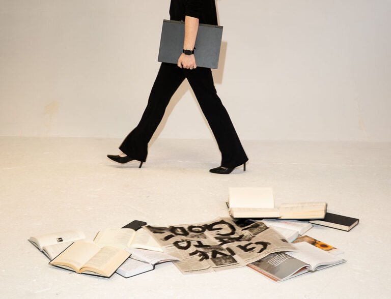 Carly walking next to books and Bible